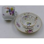 A MEISSEN CUP AND SAUCER PAINTED WITH SPRAYS OF WILD FLOWERS.