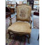 A FRENCH CARVED GILTWOOD ANTIQUE LOUIS XV STYLE ARMCHAIR WITH FLORAL TAPESTRY BACK PANEL.