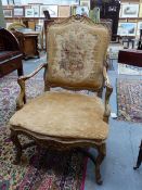 A FRENCH CARVED GILTWOOD ANTIQUE LOUIS XV STYLE ARMCHAIR WITH FLORAL TAPESTRY BACK PANEL.