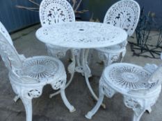 A PAINTED PATIO TABLE AND FOUR CHAIRS.