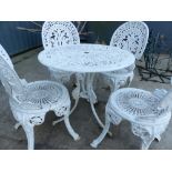 A PAINTED PATIO TABLE AND FOUR CHAIRS.