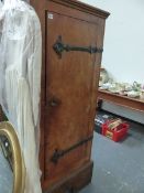 AN UNUSUAL ELM HALL CABINET WITH WROUGHT IRON HINGES.