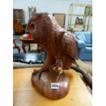 A CARVED HARDWOOD FIGURE OF AN OWL.