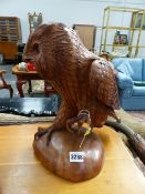 A CARVED HARDWOOD FIGURE OF AN OWL.