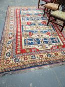A LARGE HANDWOVEN EASTERN RUG OF GEOMETRIC DESIGN.