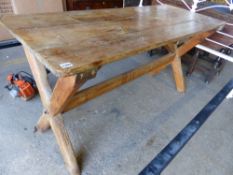 A PINE X-FRAME KITCHEN TABLE.