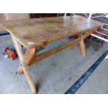 A PINE X-FRAME KITCHEN TABLE.