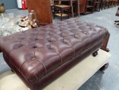 A LARGE LEATHER UPHOLSTERED STOOL.