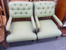 A PAIR OF VICTORIAN BUTTON BACK ARMCHAIRS.