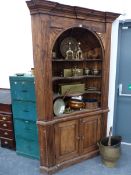 A LARGE GEORGIAN STYLE PINE BARREL BACK CORNER CABINET.