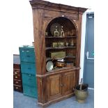 A LARGE GEORGIAN STYLE PINE BARREL BACK CORNER CABINET.