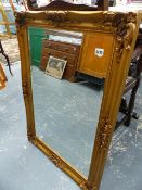 A GILT FRAMED WALL MIRROR.