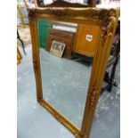 A GILT FRAMED WALL MIRROR.