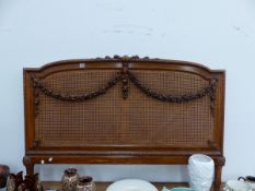 A CARVED WALNUT HEADBOARD.