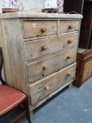 AN ANTIQUE PINE CHEST OF DRAWERS.