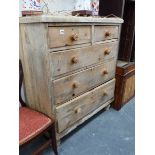 AN ANTIQUE PINE CHEST OF DRAWERS.