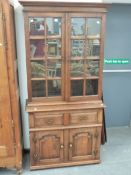 A SMALL 18th.C.STYLE GLAZED BOOKCASE ON CABINET.