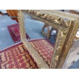 A LARGE VICTORIAN CARVED GILT WOOD FRAMED WITH LATER MIRROR PLATE.