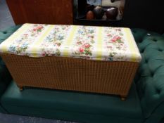 A LLOYD LOOM OTTOMAN.