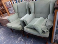 A PAIR OF GEORGIAN STYLE WING BACK ARMCHAIRS.