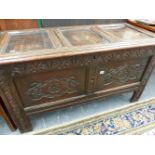 AN 18th.C.OAK COFFER WITH THREE PANEL TOP OVER TWIN CARVED PANEL FRONT.