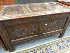 AN 18th.C.OAK COFFER WITH THREE PANEL TOP OVER TWIN CARVED PANEL FRONT.