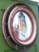 AN UNUSUAL DRUM FRAMED CONVEX WALL MIRROR.