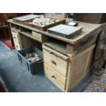 A LARGE PINE SLOPE TOP LIBRARY DESK WITH DRAWERS TO BASE.