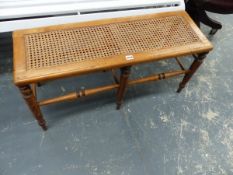 A VICTORIAN WALNUT WINDOW SEAT WITH CANE TOP.