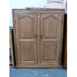 A VICTORIAN PINE PANEL DOOR LOW CABINET WITH SHELVED INTERIOR.