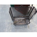 AN ARTS AND CRAFTS WROUGHT IRON FIRESIDE SET, A FIRE GRATE AND FIREGUARD.