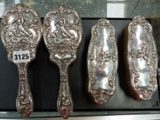 A HALLMARKED SILVER FOUR DRESSING TABLE BRUSH SET, DATED BIRMINGHAM 1908, WITH CHERUB DESIGN.