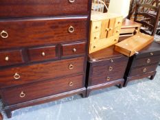 A STAG CHEST OF DRAWERS AND MATCHING BEDSIDE CHESTS.