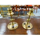 A PAIR OF ARTS AND CRAFTS BRASS CANDLESTICKS INSET WITH CABUCHON STONES