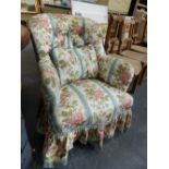A VICTORIAN FLORAL DECORATED BUTTON BACK ARMCHAIR.