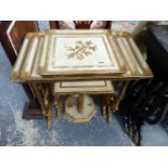 A NEST OF GILT DECORATED OCCASIONAL TABLES.