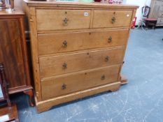 A LATE VICTORIAN ASH CHEST OF TWO SHORT AND THREE LONG DRAWERS.