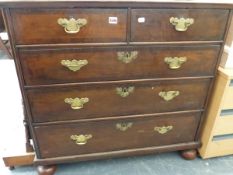 A GEORGIAN OAK AND WALNUT CROSS BANDED CHEST OF TWO SHORT AND THREE LONG DRAWERS.