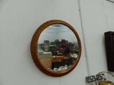 A LARGE CIRCULAR WALL MIRROR.