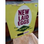 A VINTAGE NEW LAID EGGS ADVERTISING SIGN.