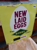 A VINTAGE NEW LAID EGGS ADVERTISING SIGN.