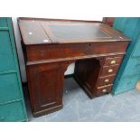 AN ANTIQUE OAK CLERK'S DESK ON TWIN PEDESTAL SUPPORTS.