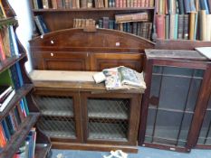 A GEORGIAN MAHOGANY ENCLOSED BOOKCASE UPPER SECTION AND A BRASS GRILL DOOR CABINET BASE.