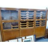 A LARGE GLAZED HABERDASHERY CABINET BY BENNETT & JENNISON.