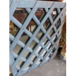 A PAINTED FRAMED LATTICE MIRROR.