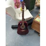 AN ACCOUSTIC GUITAR AND STAND.