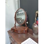 A REGENCY SWING MIRROR IN SERPENTINE BASE.