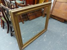 A LARGE GILT FRAMED MIRROR.