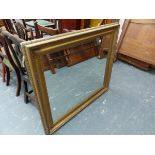 A LARGE GILT FRAMED MIRROR.