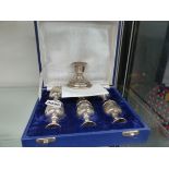 A SILVER CANDLESTICK TOGETHER WITH WHITE METAL EGG CUPS